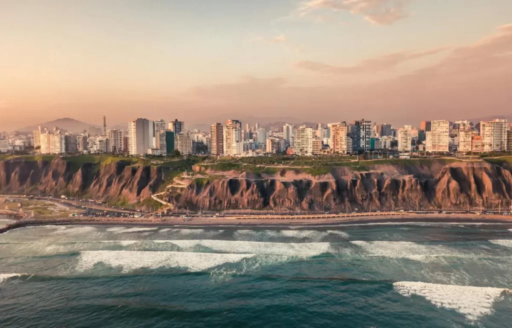 Panoramic view of Lima, Peru showing the Pacific coast, city skyline, and coastal cliffs in Miraflores.