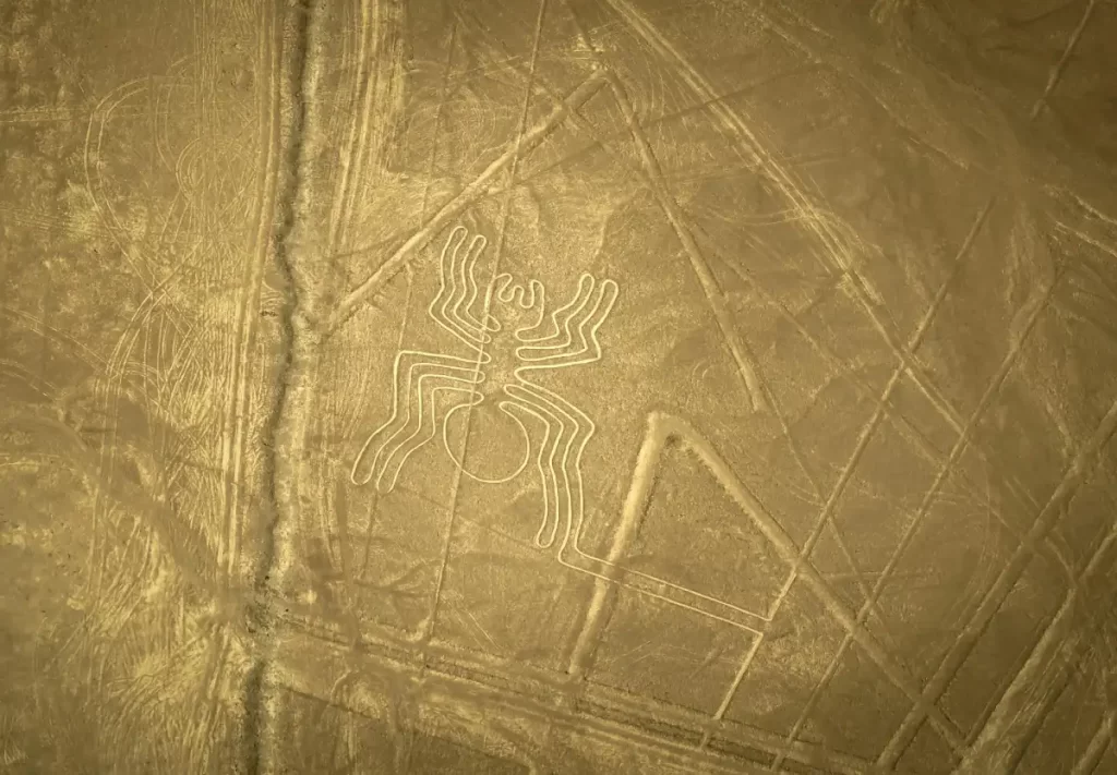 Aerial view of the Nazca Lines showing the spider geoglyph etched into the desert floor in southern Peru.