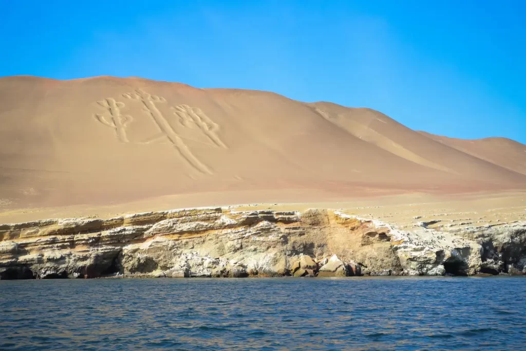 The Paracas Candelabro, a giant trident-shaped geoglyph carved into the desert hills overlooking the Pacific Ocean in southern Peru.