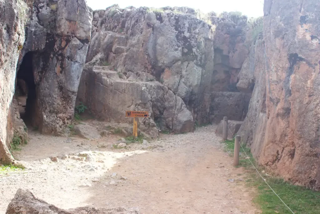 Inside the Inca Chinkana in Cusco (2025): Breakthrough Excavations Beneath Sacsayhuamán 8 Entrance to the Small Chinkana (Chinkana Chica) at Sacsayhuamán, with the wooden directional sign visible at the access point (photo taken 2025)