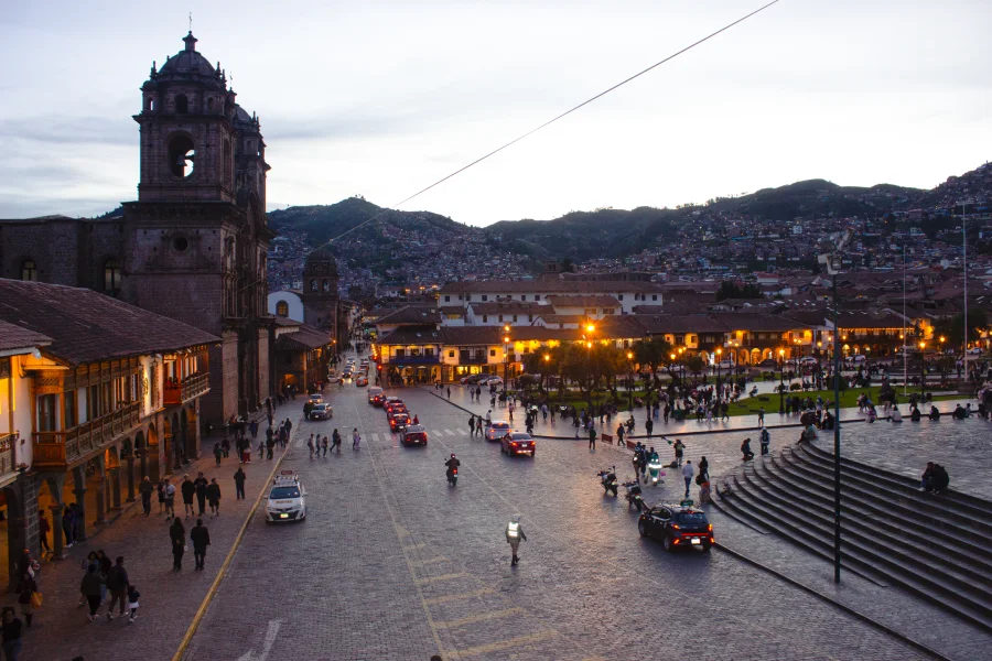 Evening view of Cusco’s Plaza de Armas with colonial architecture and city lights in the Andes