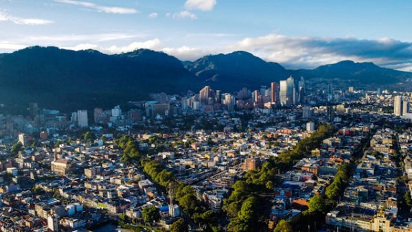 Panoramic aerial view of Bogotá, Colombia surrounded by the Andes mountains during sunset